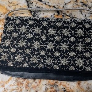 Vintage clutch. Black velvet with gold metal embellishment. Good condition.